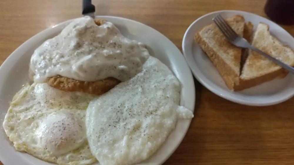 Country Fried Steak Eggs over Medium and Grits