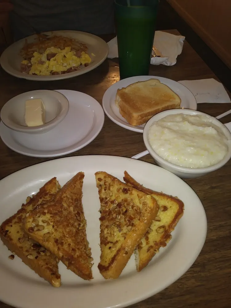 Pecan Crusted French Toast with a Side of Grits Scrambled Eggs and Ham with a Side of Toast